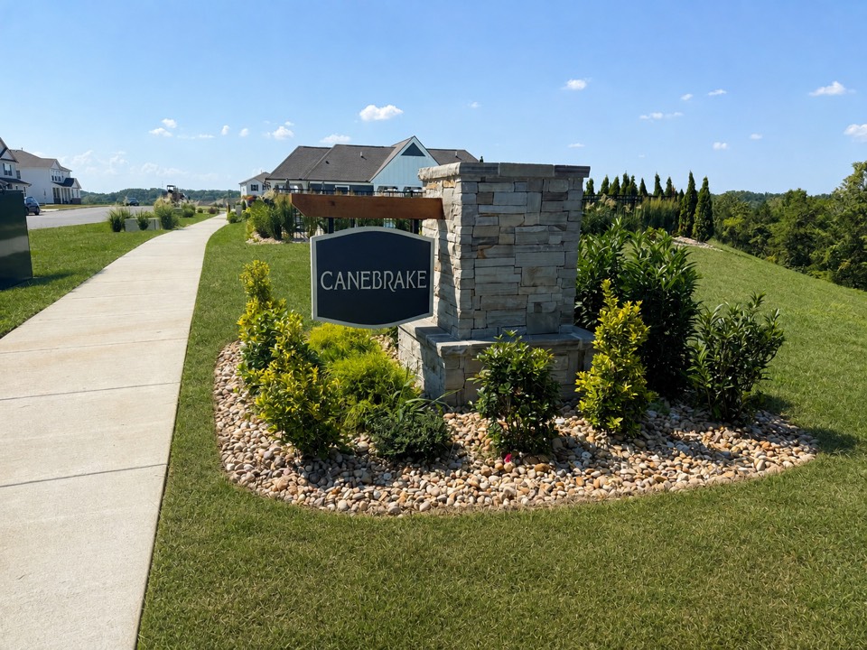 Stone Canebrake subdivision entrance sign beside the sidewalk